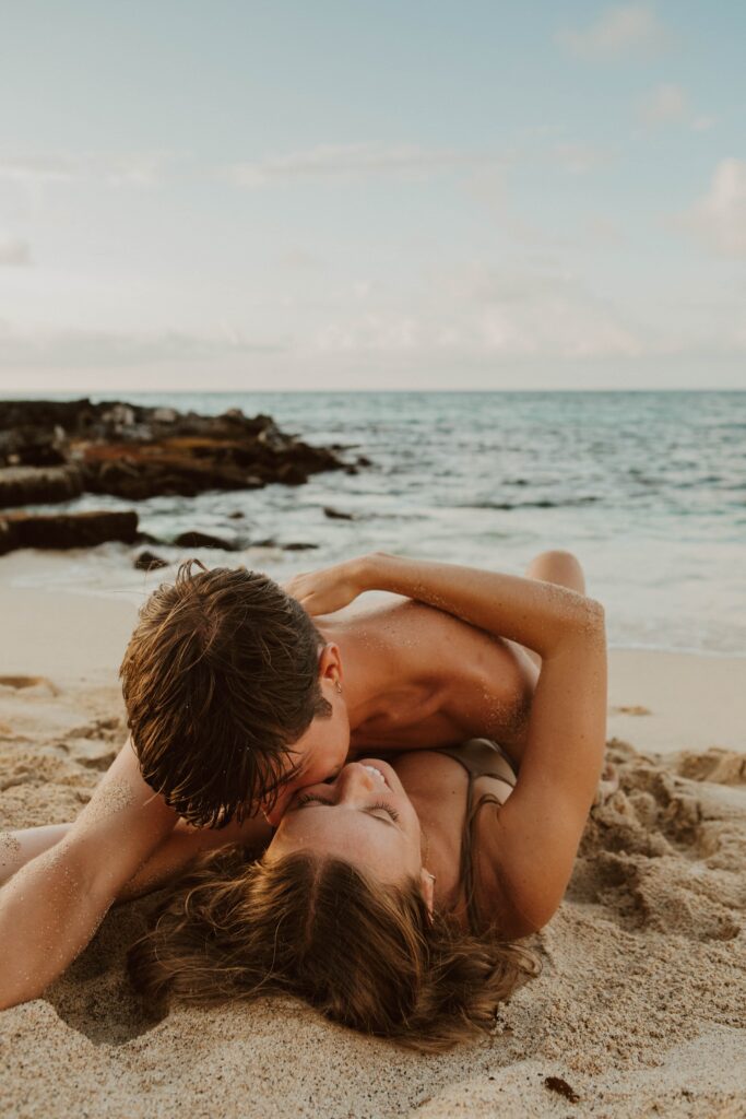 couple laying in sand destination elopement photographer