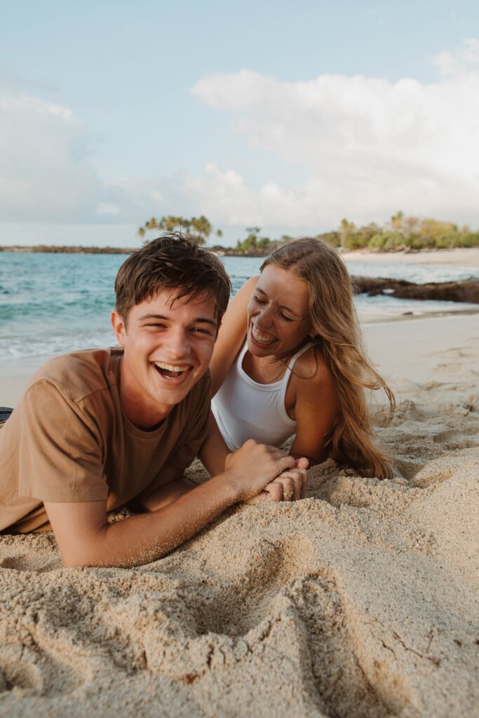 couple laughing in the sand hawaii elopement photographer packages