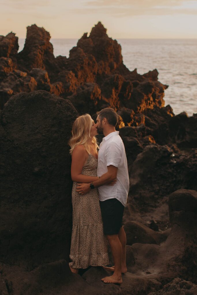 couple kissing on cliffs on the beach