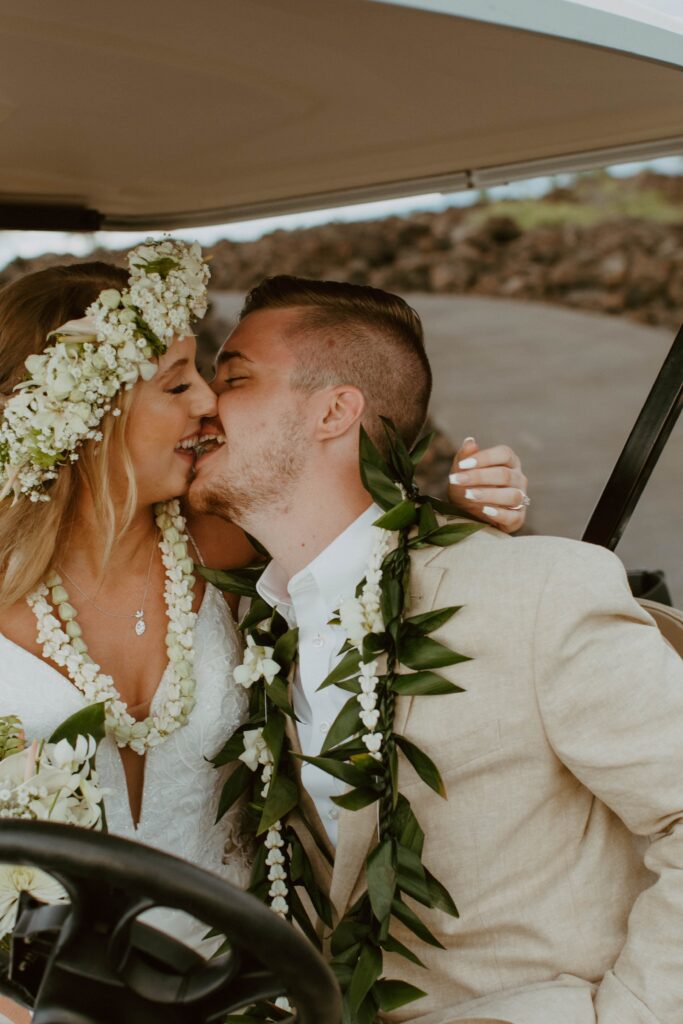 bride and groom kissing in a golf cart