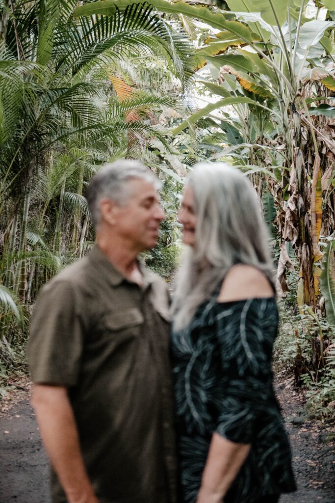 couple standing under banana trees destination elopement photographer 
