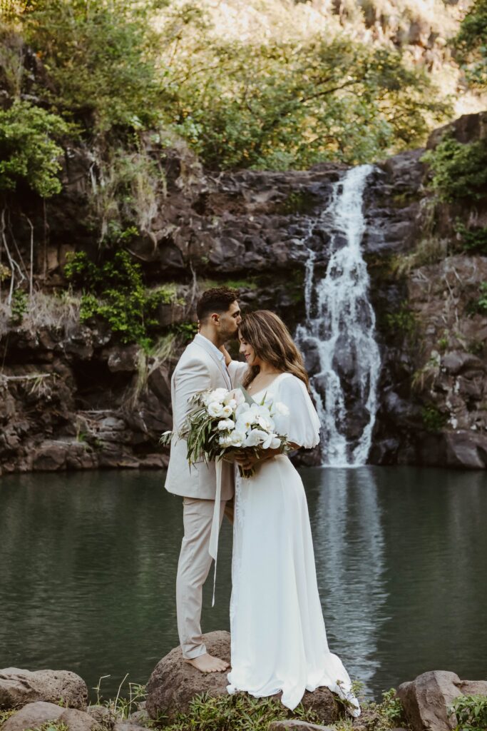 bride and groom in front of waterfall elopement photographer