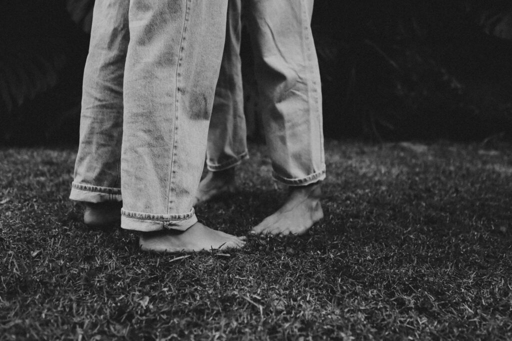 grey and white photo of couples feet in blue jeans Sedona Elopement Photographer