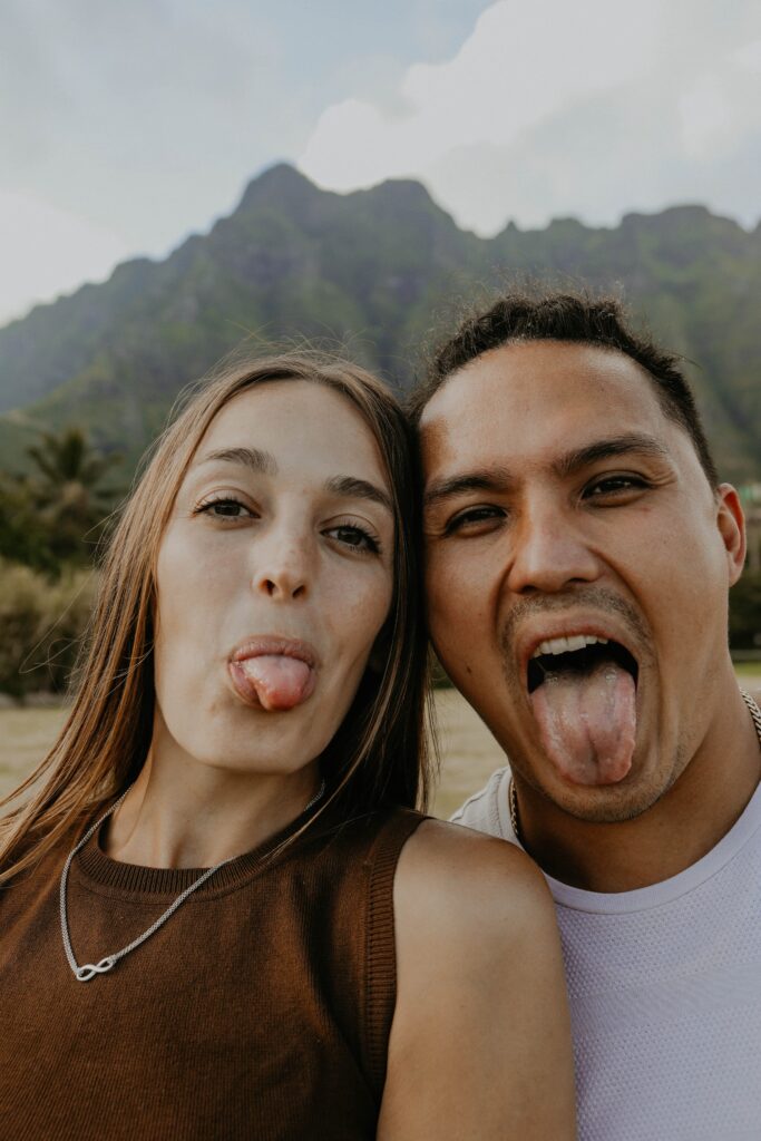couple making silly face with mountains in back ground elope in san diego