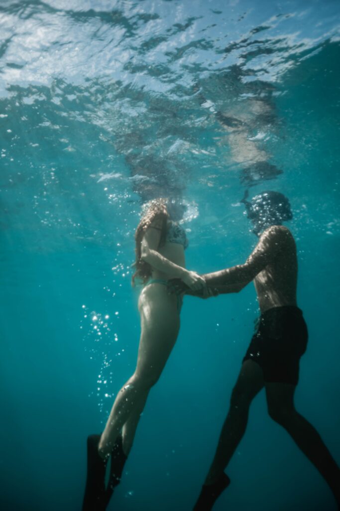 couple holding hands underwater hawaii adventure elopement